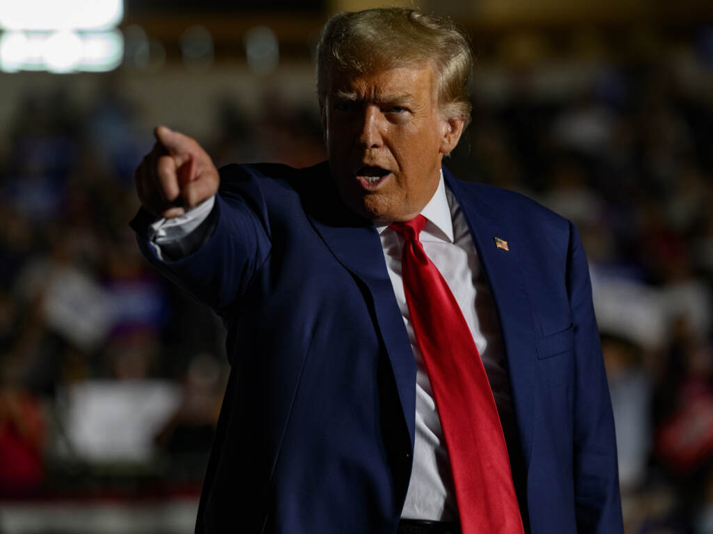 Trump points towards something.