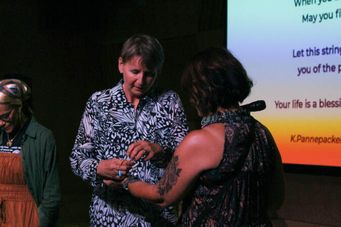 Audience members talk to one another.