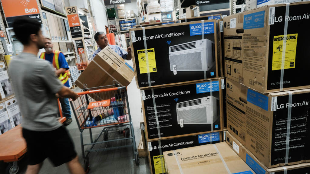 People shop for air conditioners during a heat wave last week in New York City. Many people who live in public housing can't afford such units or the utility bills that come with them — and there's no federal requirement for air conditioning.
