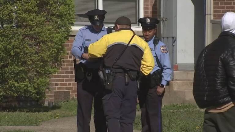 police officers standing outside of a home