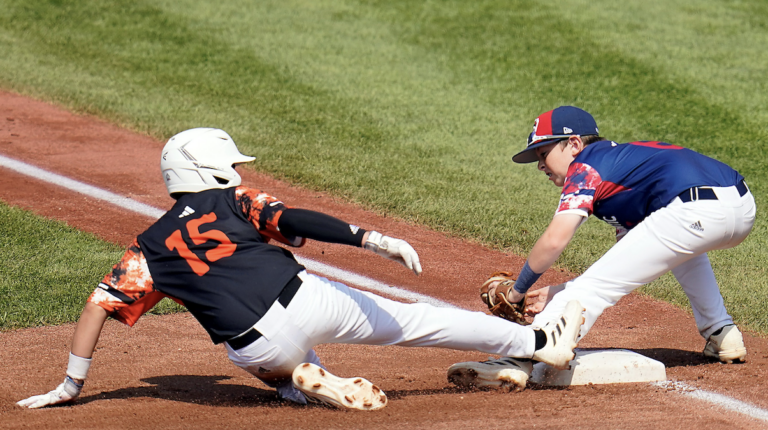Smithfield, R.I.'s Brayden Castellone (15) slides safely into third base under the tag of Media, Pa.'s Patrick Diedrich