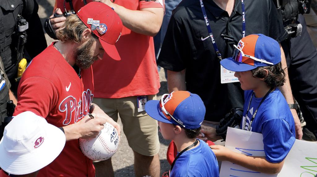 Philadelphia Phillies Bryce Harper signs autographs for New Albany, Ohio's Little League World Series team members Jake Gilmer and Alex Behaein