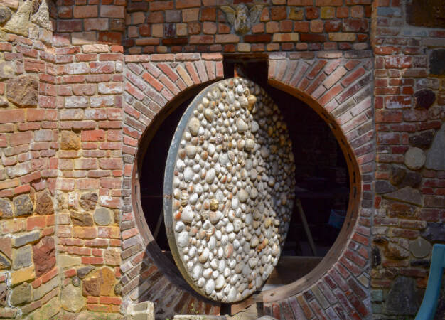 A close-up of a door made from shells