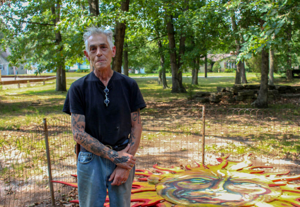 Jeffrey Tirante, 63, stands in front of a painting of a sun
