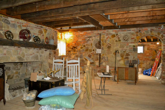 A room with stone walls and sparse furniture.