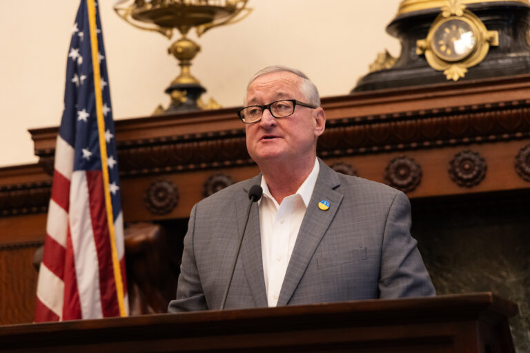 Mayor Jim Kenney speaks at a podium.