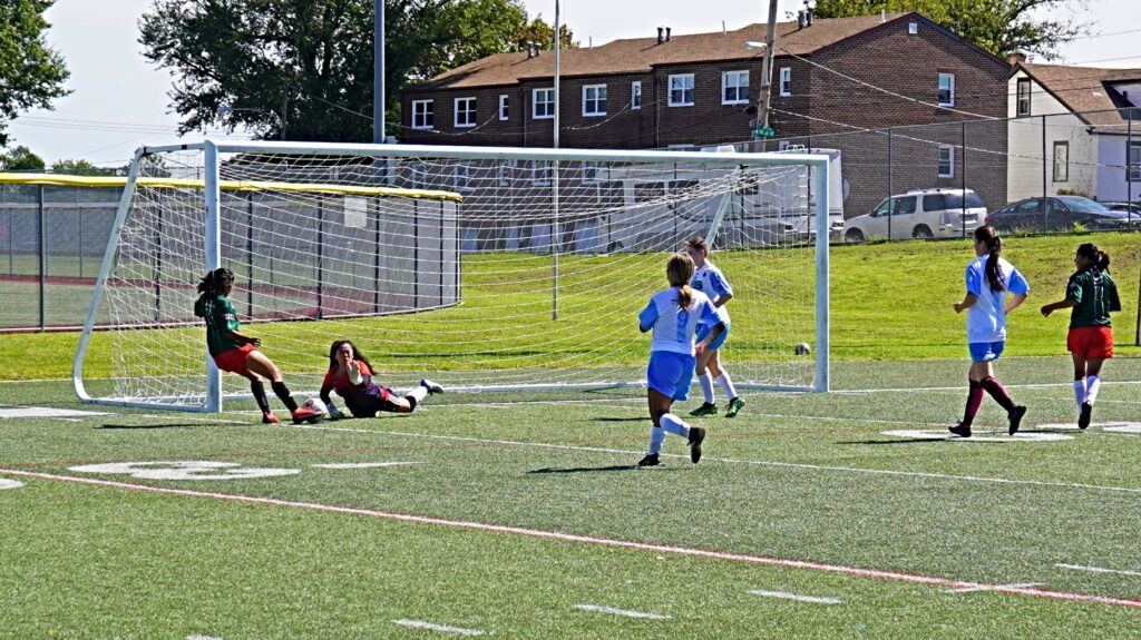 The goalkeeper for the Guatemalan women's team dives to save the ball against Mexico