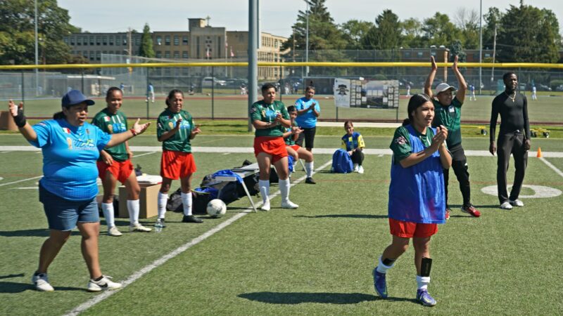 Substitutes and coaches for the Mexico women's team celebrate a goal