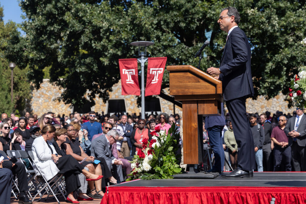 Gregory Mandel speaks at a podium.