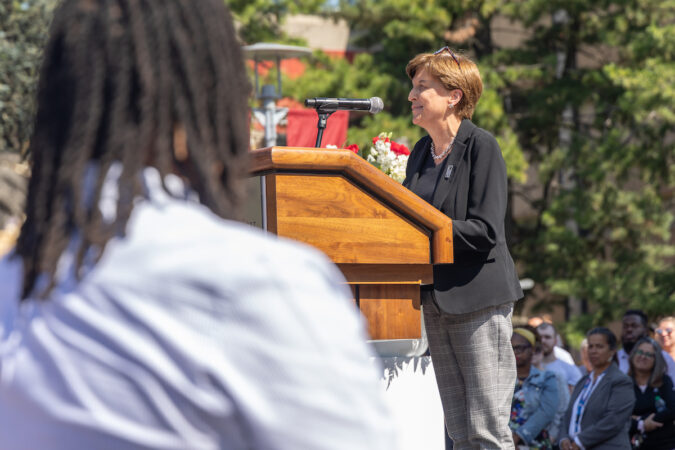 Marylouise Esten speaks at a podium.