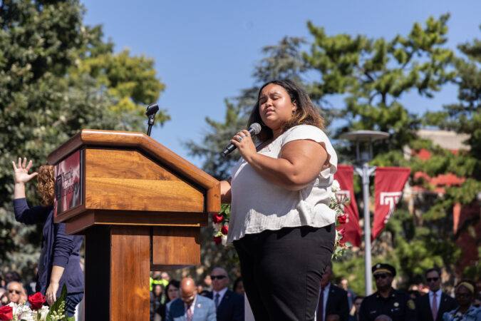 Jacqueline Johnson sings into a microphone.