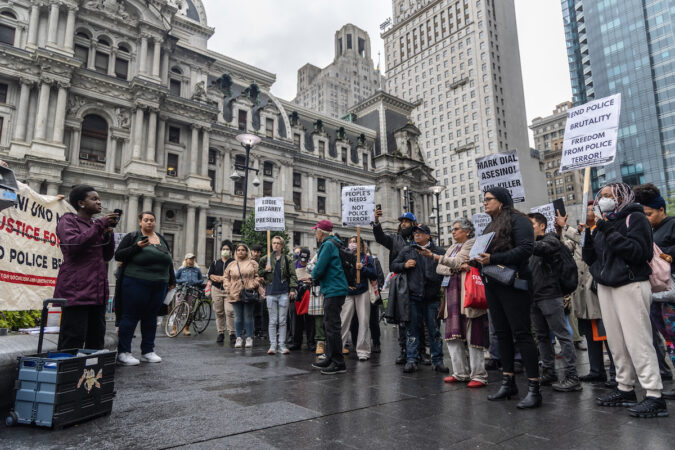 Protesters stand outside of City Hall.