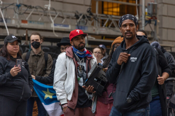 MOVE bombing victim Mike Africa stands with protesters.