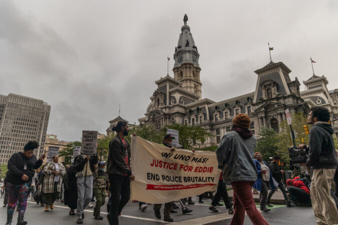 Protesters hold a sign advocating for 