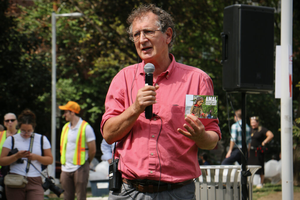 David Lan speaks into a microphone
