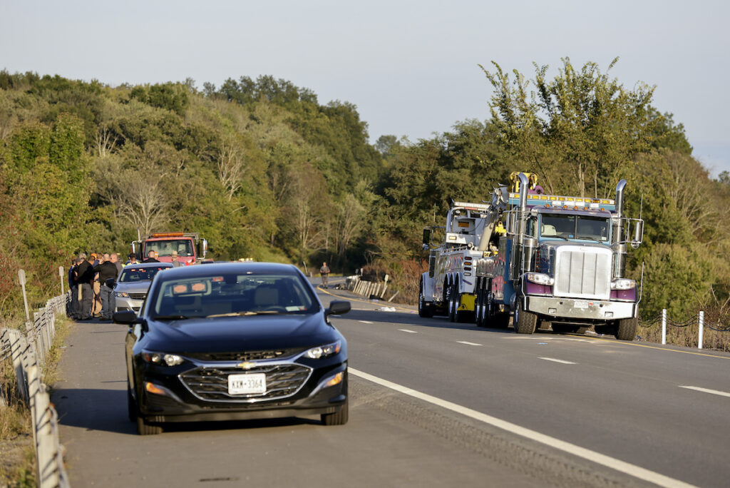 Bus Crash New York Emergency responders gather near the scene of a fatal bus crash, in Wawayanda, N.Y., Thursday, Sept. 21, 2023. A charter bus carrying high school students to a band camp hurtled off a New York highway and down an embankment, officials said. (AP Photo/Adam Hunger)