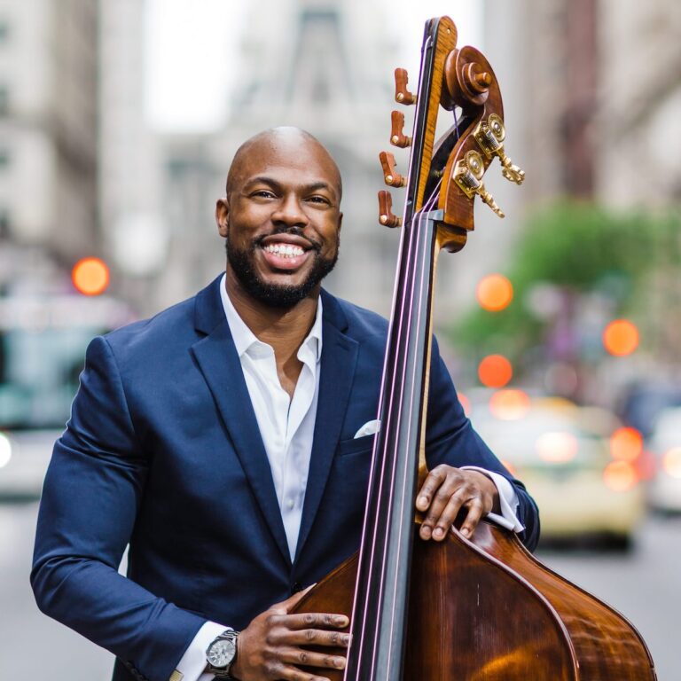 Joseph Conyers poses with a bass in front of Philadelphia City Hall.