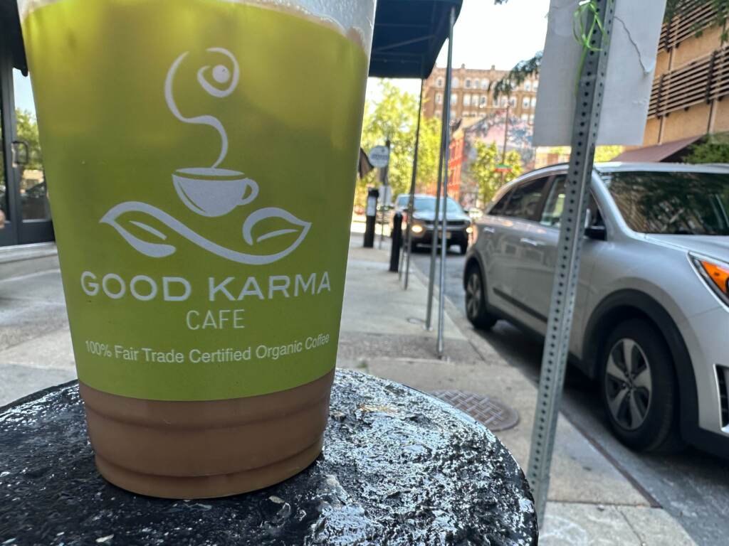 GoodKarmaCafeCoffee Coffee cup from Good Karma Cafe sitting on a table.