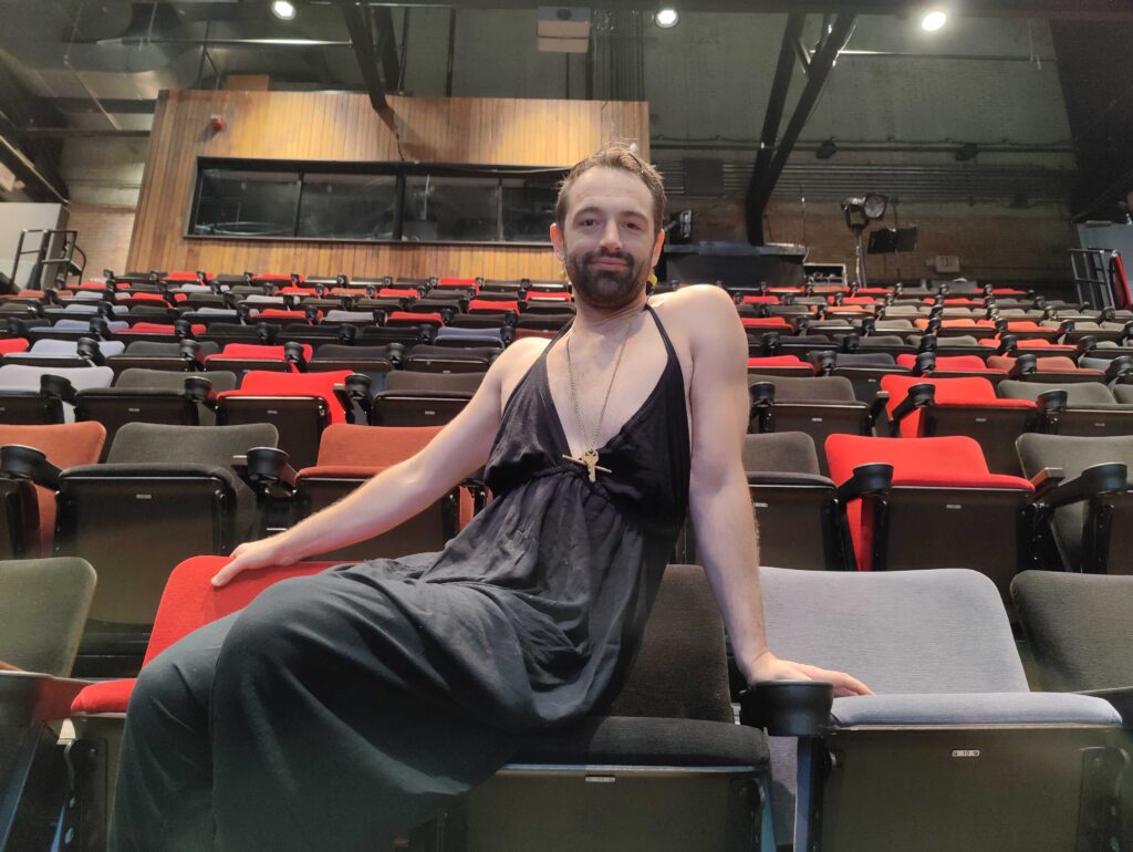 John Jarboe seated in an audience seat at FringeArts