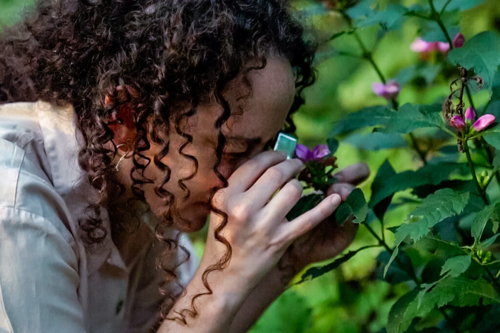 Movers-Makers-Promo-CG A person looking at closely at a bush with