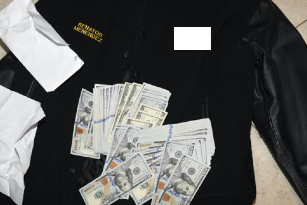 US Senator Indicted A jacket bearing Menendez's name, along with cash from envelops found inside the Jacket during a search by federal agents of the senator's home in Harrison