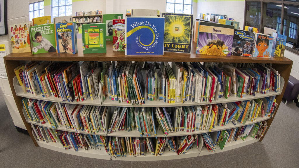 Education Book Bans Books on shelves in a library