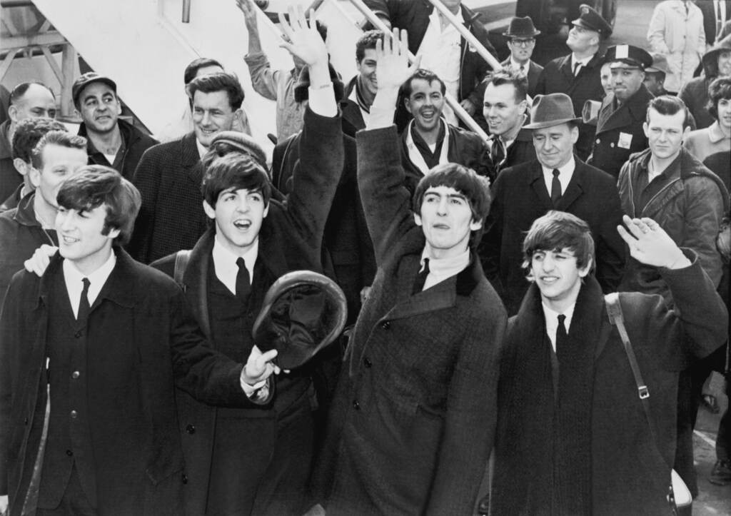 The Beatles waving to fans in 1964