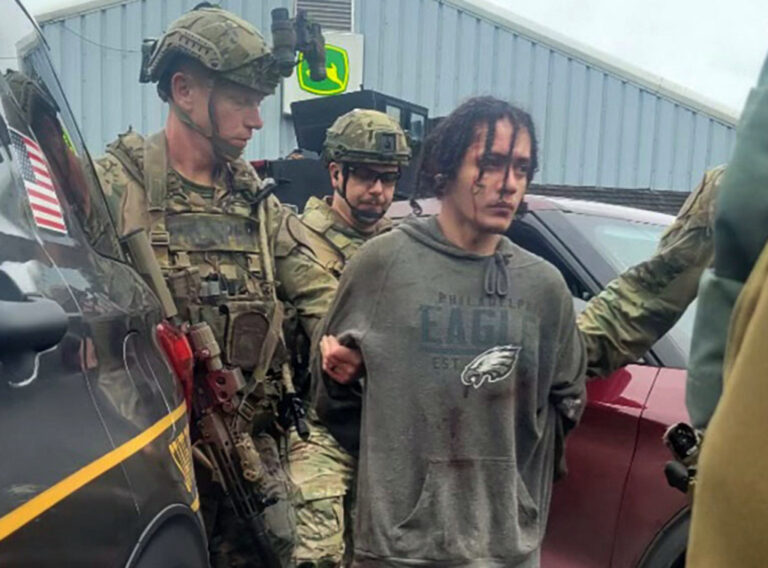 Danelo Cavalcante in custody, flanked by officers