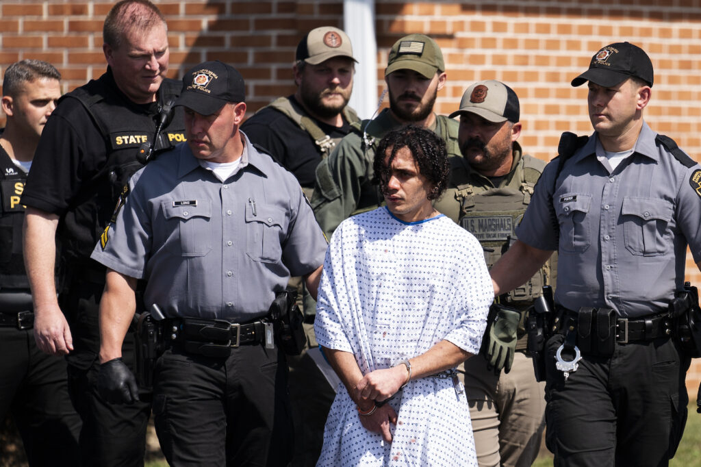 Prisoner Escape-Pennsylvania Law enforcement officers escort Danelo Cavalcante from a Pennsylvania State Police barracks in Avondale Pa.