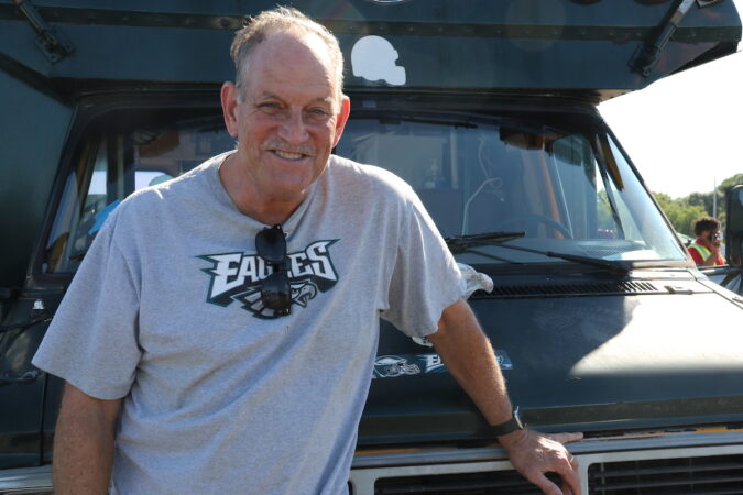 JIm Gertie poses with an Eagles shirt on outside of his car.