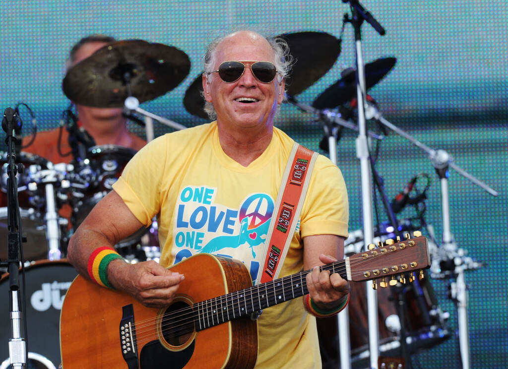 Musician Jimmy Buffett performs onstage at Jimmy Buffett & Friends: Live from the Gulf Coast, a concert presented by CMT at on the beach on July 11, 2010 in Gulf Shores, Alabama. (Rick Diamond/Getty Images for CMT)