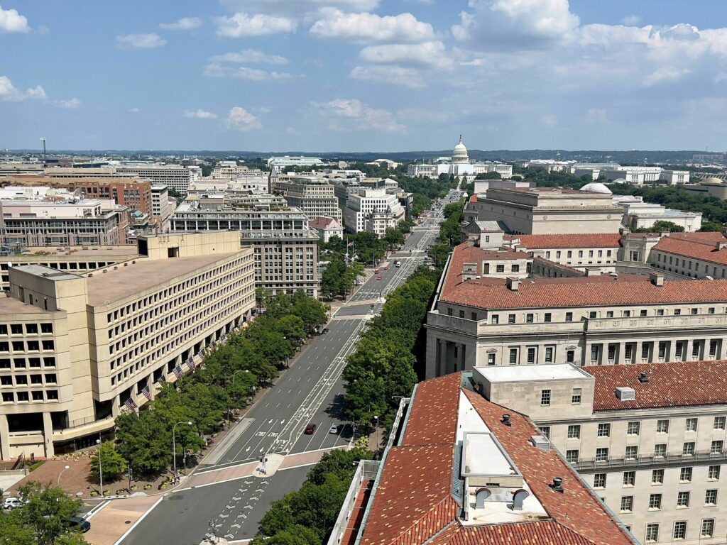 The federal government, the nation’s largest employer, is urging a return to office for federal employees this fall. A government report found that in the first three months of 2023, building occupancy at 17 federal agency was 25% or less. aerial photo of Washington D.C.
