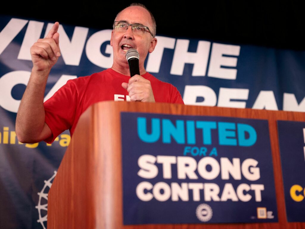 UAW President Shawn Fain speaks as UAW members and their supporters gather for Solidarity Sunday at the UAW Region 1 office in Warren, Mich., on Aug. 20. The UAW has started an unprecedented strike against all three big automakers. United Automobile Workers (UAW) President Shawn Fain speaks as UAW members and their supporters gather for Solidarity Sunday at the UAW Region 1 office