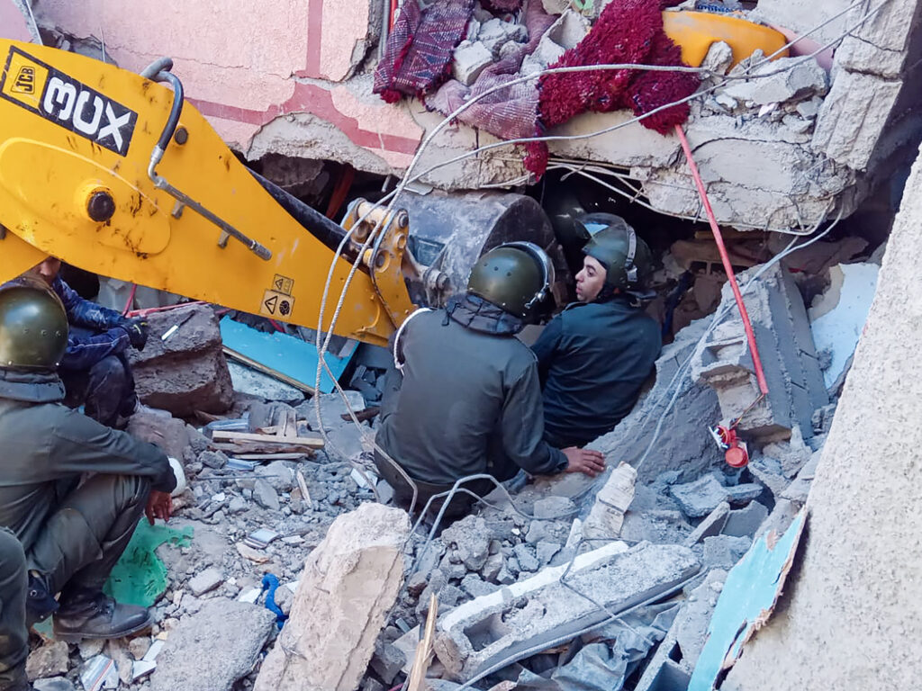 Rescue workers search for survivors in a collapsed house in Moulay Brahim, in Morocco's Al Haouz province, on Saturday after an earthquake.