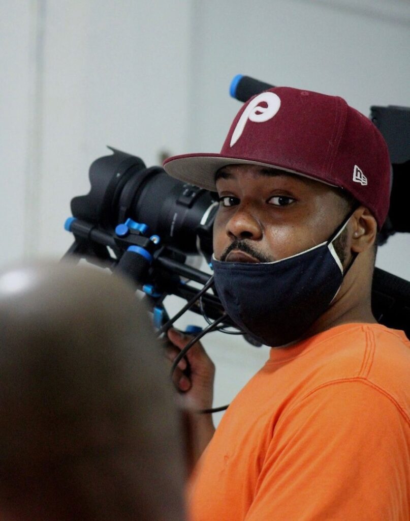 Director Kaloni Davis holds a camera.
