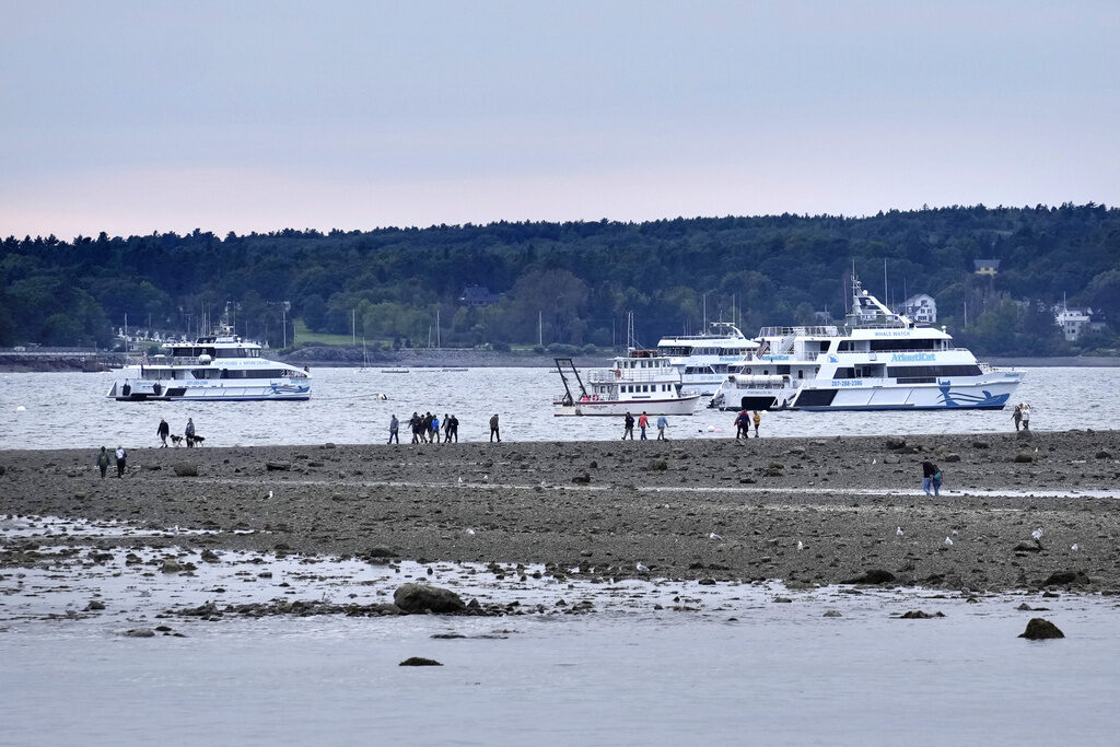Tropical Weather Visitors walk along a sand bar at low tide in advance of Hurricane Lee, Friday, Sept. 15, 2023, in Bar Harbor, Maine.