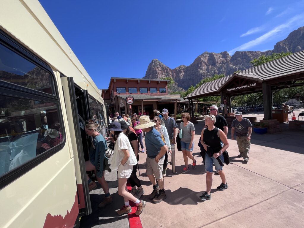 Tourists board a shuttle into Zion National Park, in Utah. The state government will pay for the park to stay open during the government shutdown, in order to keep tourist revenue flowing to nearby towns. Tourists board a shuttle in Zion Naitonal Park.