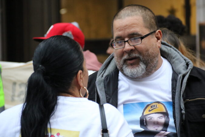 Eddie Irizarry Sr. speaking to another family member