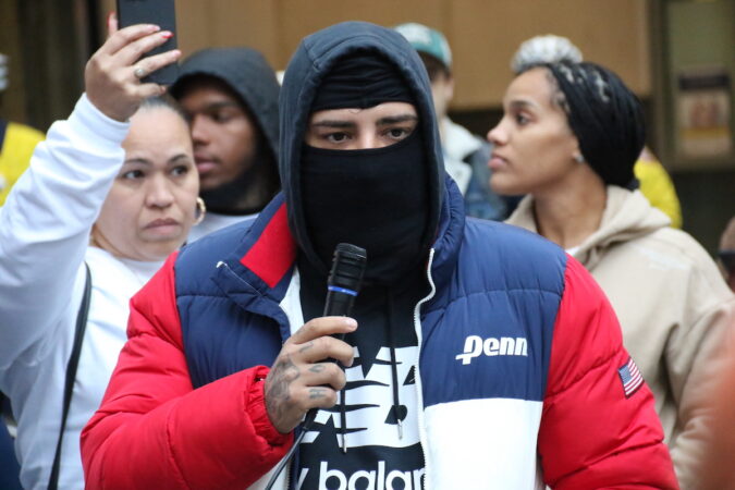 Johnathon Rivera speaks into a microphone.