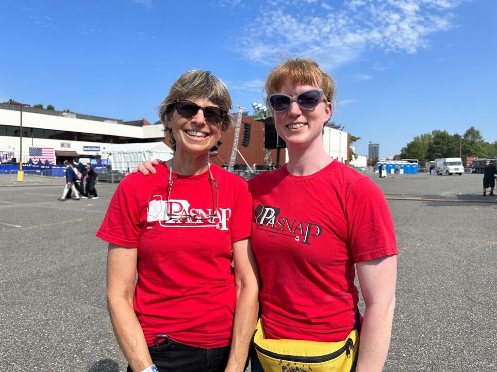 Two women wearing red shirts that say 'PA SNAP'