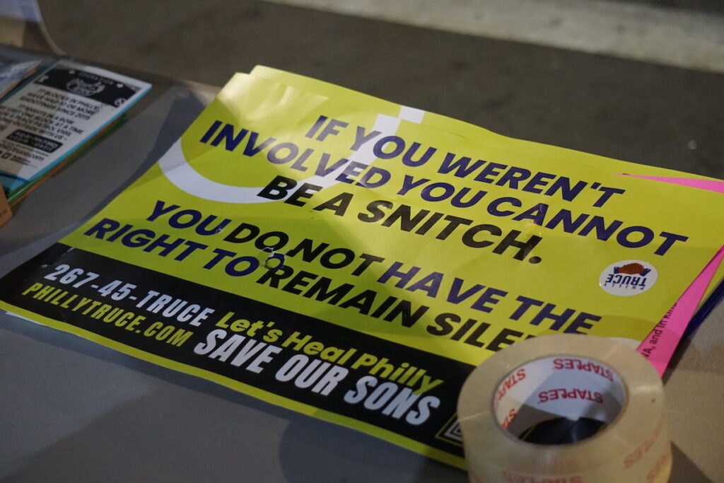 A poster available at Operation Hug the Block's base tent reads "If you weren't involved, you cannot be a snitch."