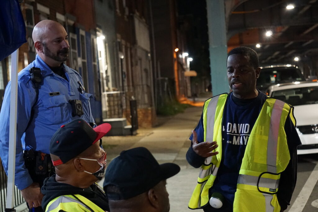 operation-hug-the-block-4 Emmanuel Bussie speaks to a group of volunteers.
