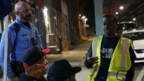 Emmanuel Bussie speaks to a group of volunteers.