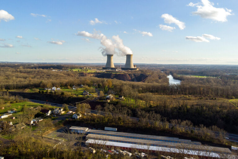 A power plant is seen in the distance.