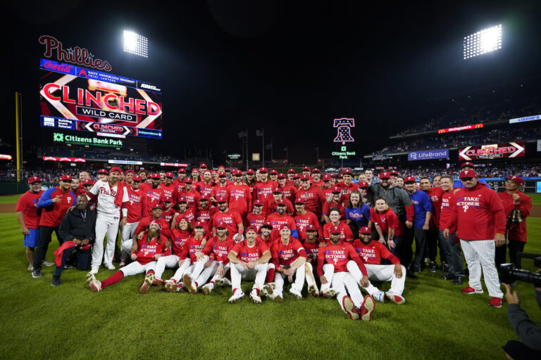 The Philadelphia Phillies pose after clinching a wild-card playoff spot, Tuesday, Sept. 26, 2023, in Philadelphia.