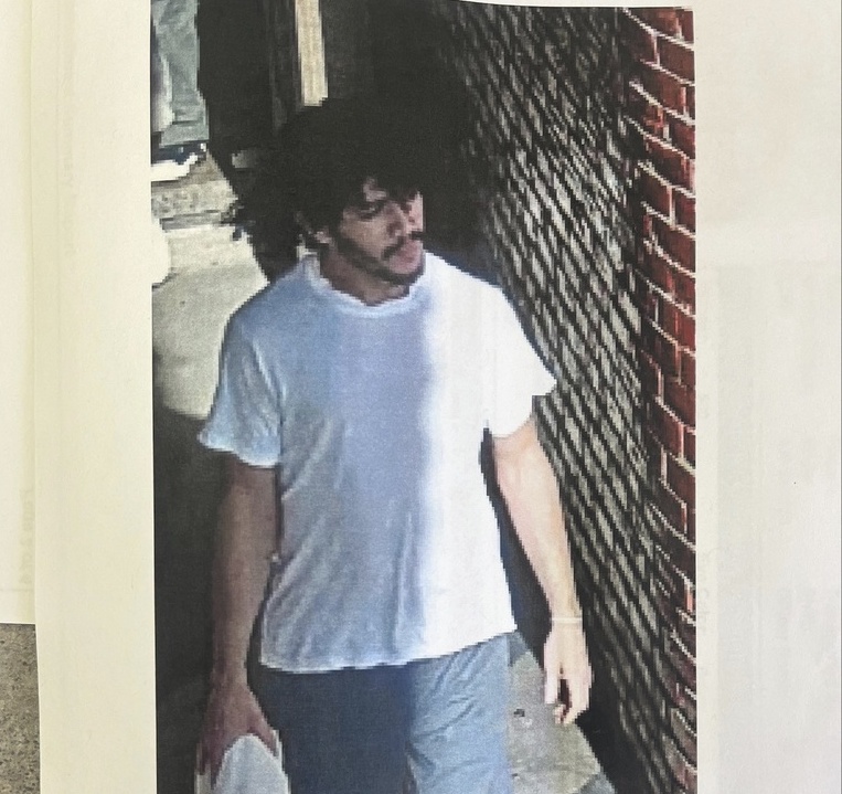 Prisoner Escape Pennsylvania A prisoner who has escaped walks down the street.