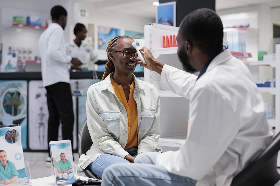 Racial equity health care clinical trials A doctor takes a patient's temperature
