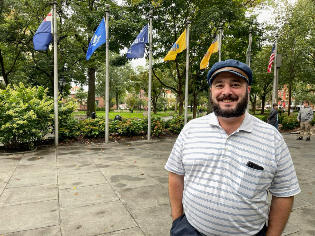 simonjoseph-flags-vexillology-washingtonsquare Philadelphia vexillophile Simon Joseph at the Tomb of the Unknown Revolutionary War Soldier in Washington Square, which flies flags associated with all original 13 states.