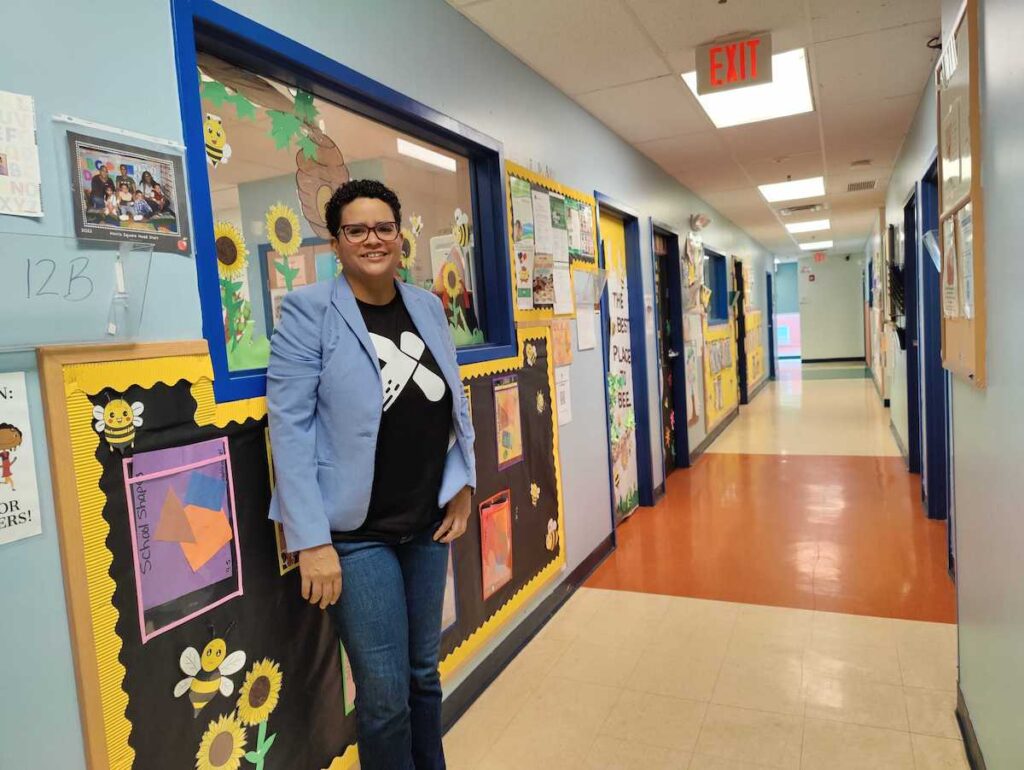 xiente-1 Dr. Michelle Carerra Morales poses for a photo in a hallway