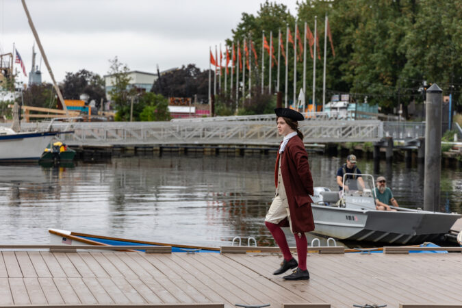 An actor playing Benjamin Franklin walks near the Delaware Riverfront.